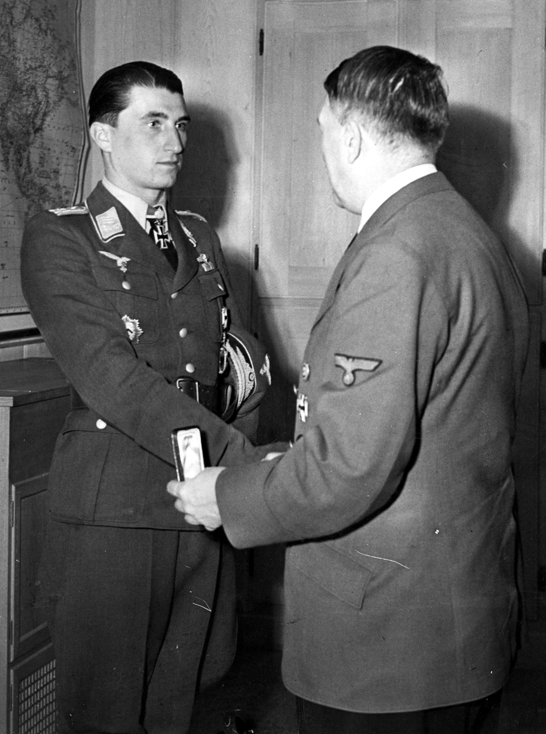 Adolf Hitler awards the night's Cross with Golden Oak Leaves, Swords, and Diamonds to ace pilot Walter Nowotny for his 250th victory